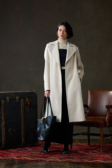Fall/Winter 2025 Women's Lookbook                                                                                                                                                                                                                         , Black Stretch Gown With Cream Cashmere Top Coat - Holland & Sherry